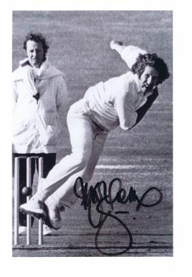 MAX WALKER: A black and white picture depicting Max Walker bowling, autographed by Walker