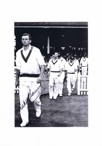 RICHIE BENAUD: A black and white picture of Benaud walking out with the team, autographed by Benaud