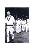 RICHIE BENAUD: A black and white picture of Benaud walking out with the team, autographed by Benaud