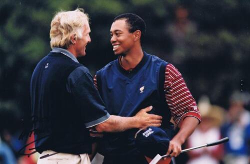 GREG NORMAN: A colour picture featuring Greg Norman and a Young Tiger Woods, personally inscribed and signed by Greg Norman
