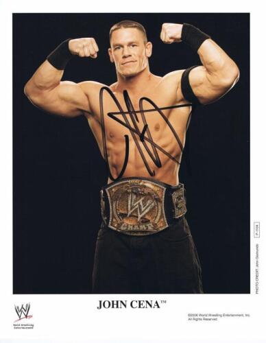 JOHN CENA: A official WWE publicity card depicting John Cena, autographed by John Cena. ManiacJoe COA sticker.