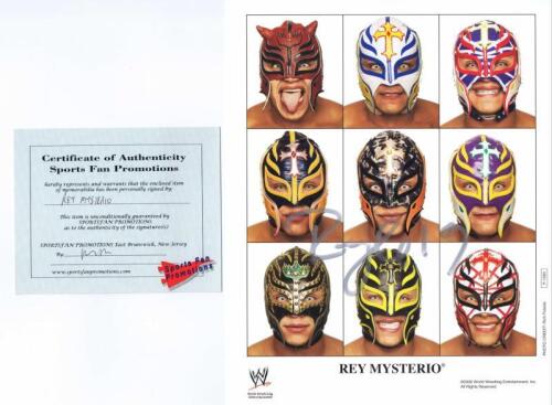 REY MYSTERIO: A official colour publicity card depicting a collage of Rey Mysterio and his masks, autographed by Rey Mysterio with COA.