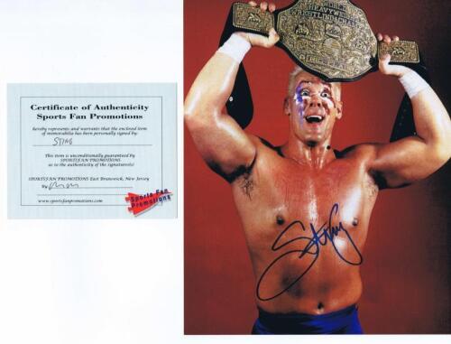 STING: A colour picture of 'Sting' depicted holding up his World Heavyweight Wrestling Champion Belt, autographed by Steve Borden