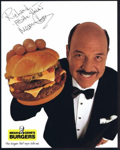 MEAN GENE: A publicity card depicting Gene Okerlund holding a beef burger, personalised autograph by Mean Gene