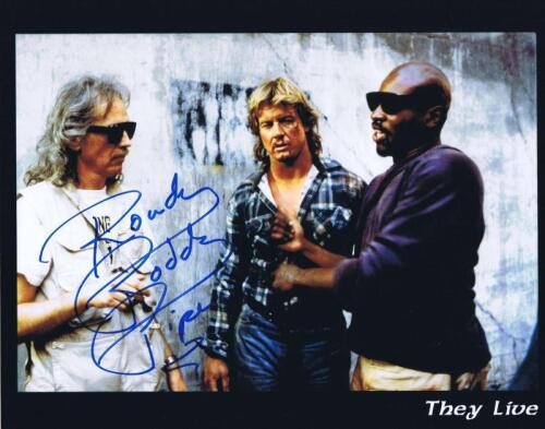 ROWDY RODDY: A picture depicting cast members of 'They Live', autographed by Rowdy Roddy Piper