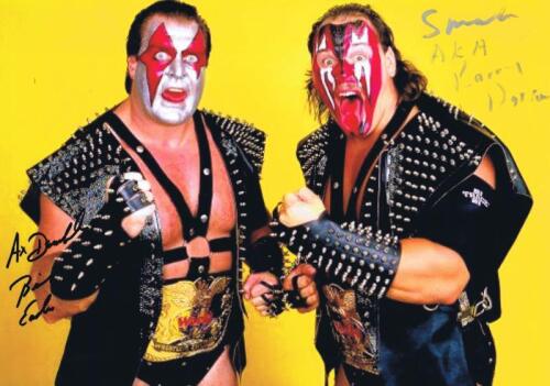 AX & SMASH: A colour photo depicting Ax & Smash, autographed by both