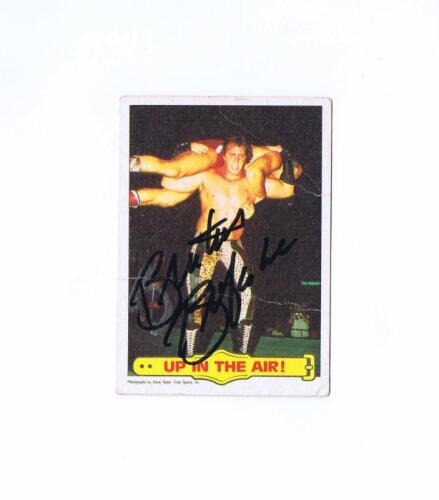BRUTUS BEEFCAKE: A 1986 Titan Sports card No 26, autographed by Brutus Beefcake