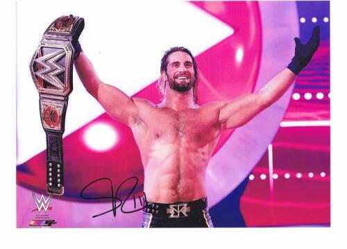 SETH ROLLINS: A autographed colour picture of Seth Rollins picture holding his belt