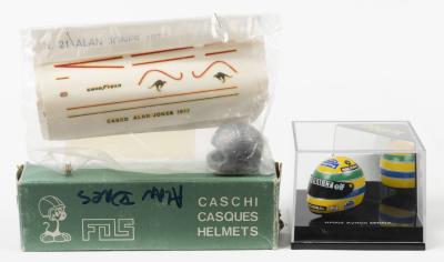 HELMETS: Two 1/12th scale model helmets. ONYX Ayrton Senna helmet in 'RENAULTelf NACIONAL' livery (HF002) & FOS Alan Jones white metal helmet