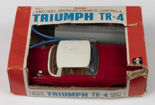 TRIUMPH: A Bandai&nbsp;remote control Triumph TR4 Japanese lithographed tin toy (4211). Boxed