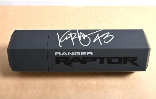 FORD RANGER RAPTOR: A black Ford RANGER RAPTOR promotional tube by FORD PERFORMANCE, with pair of black 'RAPTOR' sparco racing gloves. Tube signed by Ken Block