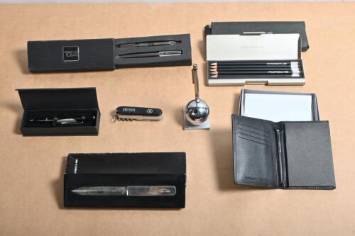 MOTORING STATIONERY: A group of pens, pencils, notepad, letter opening knife from various manufacturers including BMW, Ford Performance Vehicles, Porsche, TOCA. 'AUSSIE GRIT' nappa cow leather covered notepad