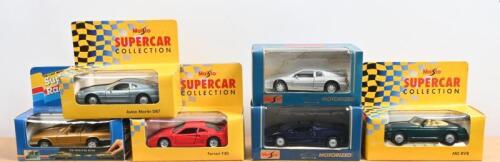 ENGLISH/EUROPEAN DIECAST: A group of six 1:43 scale diecast models predominantly by Maisto. Aston Martin, Ferrari, Jaguar models