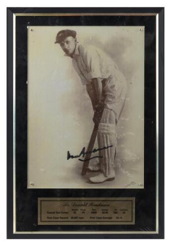 DON BRADMAN: A reproduced photo of Don Bradman mounted behind perspex on board. Photo autographed by Bradman