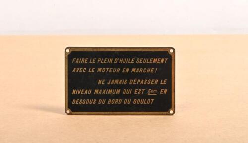 BRASS PLAQUE: A small brass plaque with French text, translated as 'Top up oil only with engine running! Never exceed the maximum level which is 5cm below the edge of the neck'