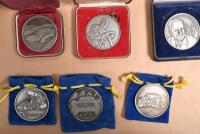 CASTLEMAINE: A collection of medallions and a silver plated trophy from the Castlemaine Lancia Rallies, the trophy 8cm high - 4
