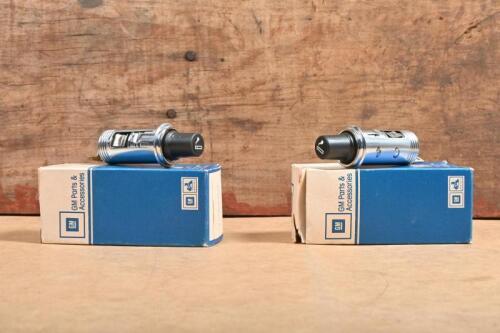 HOLDEN: Two NOS Holden HX cigarette lighters in original GM parts boxes.