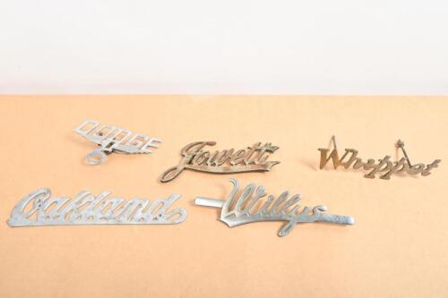 BADGES: A group of badges including Whippet, Dodge 6, Oakland, Willys and Jowett