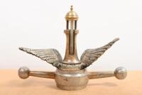 MOTOMETER: A decorative mascot combination including dog bone with wings, surmounted by a brass lighthouse thermometer