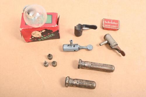 VALVES: A collection of items related to wheel valves including two early valve stem covers, three early air chucks for tire pumps and others