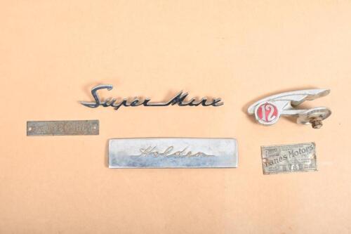 BADGES: A group of badges and plaques including Super Minx badge, Morris 12 hood ornament, Holden FJ dash badge and two Buick tags one being from Lanes Motors Melbourne
