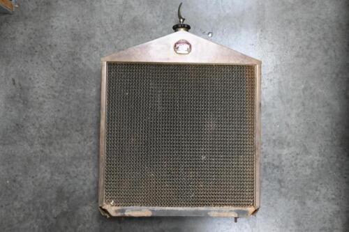 MOON: A brass 'Moon Motor Car Co' front brass radiator with enameled badge and moon ornament mounted to radiator cap, believed to be from a 1923 Moon 6-40 model.