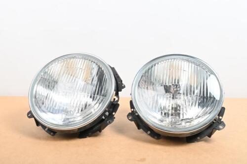 HEADLIGHTS: A pair of NOS Hella&nbsp;round H4 halogen headlights