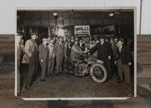 MELBOURNE TO SYDNEY RECORD: A rare original black and white photograph depicting CJ Weatherby and D Bain being welcomed by Bill Goodwin of ACV after breaking the Melbourne to Sydney sidecar record in 13 hours and 31 minutes, signed & inscribed