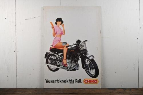 VINCENT/CHIKO: An original advertising poster featuring a lady eating a chiko roll on a Vincent Rapide motorcycle, mounted on thick gauge card, 79 x 55cm