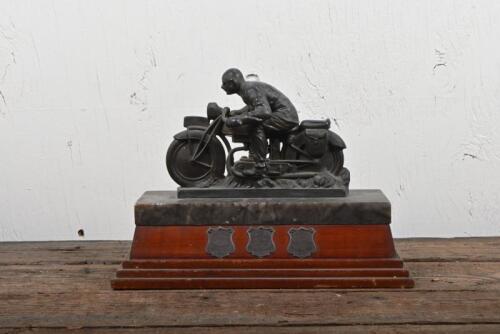 TROPHY: A cast spelter trophy featuring a 1930s motorcycle and rider on an onyx and fiddleback blackwood base