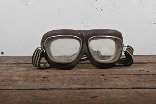 AVIATION: A pair of mid-century flying goggles with leather padding and later headband