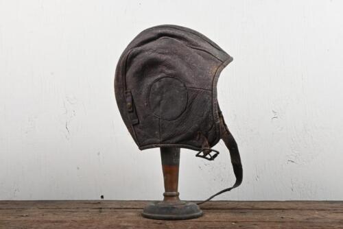 AVIATOR CAP: A leather flying aviator cap with strap.