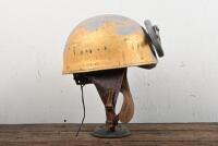 HELMET: A WWII BOMB (British Motor Bodies) dispatch riders helmet dated 1944, with leather interior and later applied winged wheel and medallion, size 6 3/4