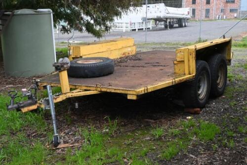 TRAILER: A yellow tandem axle vehicle trailer