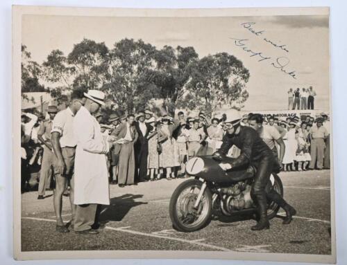 &nbsp;GEOFF DUKE OBE: A original signed photograph of famed British racer Geoff Duke on his visit to Australia in 1954, griding up on his Gilera 500/4, inscribed "Best Wishes Goeff Duke"