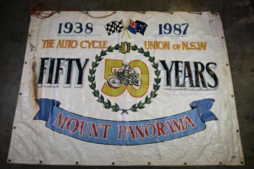 MOUNT PANORAMA: A large hand painted banner celebrating 50 years of the Auto Cycle Union of NSW 1938-1987 at Mount Panorama