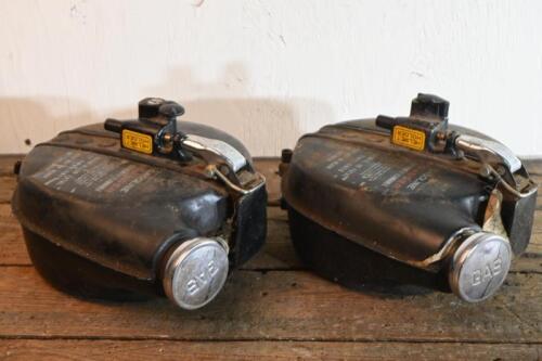 GASOLINE TANKS: Two detachable gasoline tanks with lock for helmet and the tank itself, eacjh 27cm high 23cm wide, 10.5cm deep