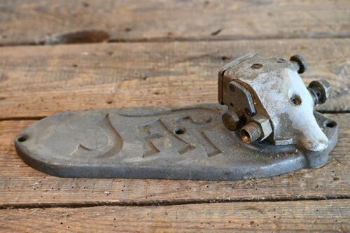 JAP: A cast 'JAP' timing chain cover, numbered on reverse 1134, with oil pump affixed