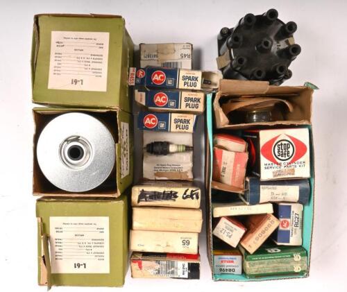 CADILLAC: A selection of 1957 Cadillac parts. Including; Twenty four spark plugs. Three L61 oil filters. A distributor cap. A thermostat. A master cylinder kit. An oil pressure switch. A stop light switch. A radiator cap. Rubber seals