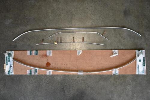 JAGUAR: E-TYPE. One NOS E-TYPE top windscreen chrome molding. Three other E-Type moldings.