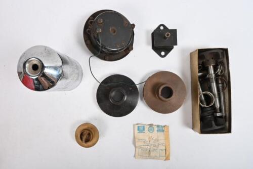 MG: "T SERIES". One horn assembly. One oil filter housing. One mount # 431874. One box of water pump parts. Two engine pulleys. One water thermostat.