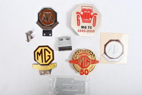MG: Badges. Four MG badges. One 50th anniversary badge. One MG TC 60th anniversary badge. One MG TC owners club badge. One "T SERIES" association badge and sticker. One badge bar mount.