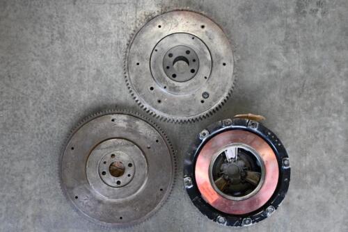MG: "T-SERIES" PARTS. One rebuilt clutch diaphragm assembly. Two flywheels with ring gear.