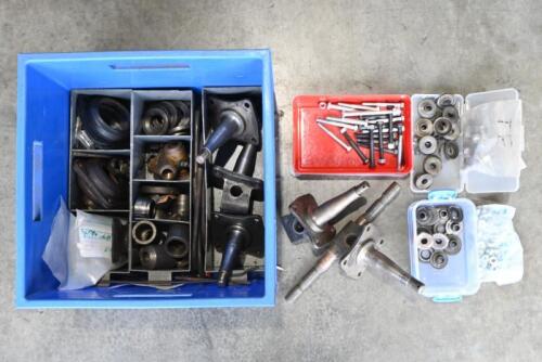 MG: "T-SERIES" PARTS. One blue box of assorted parts including four stub axles and associated suspension pieces. 4 steel mountings. Two boxes of collets. One box of differential bolts. Assorted nuts and bolts.