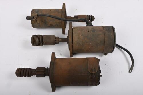 STARTER MOTORS: Three assorted starter motors in unknown condition in vintage wooden box.