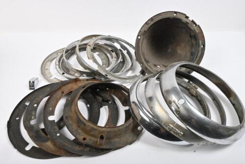 HEADLAMPS: Three headlight rims. One headlight shell. Ten headlamp mounting pieces.