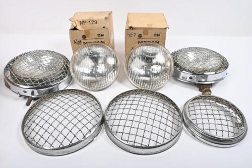 LAMPS: Two Hella driving lamps. Eight 7 inch wire mesh headlamp covers. One 5 inch mesh driving lamp cover. Two NOS 5 inch sealed beam lamps.