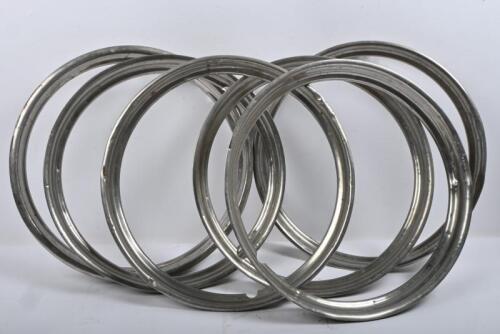 WHEEL TRIMS: One set of six 16 inch trim rings to suit Jaguar and other British cars. Please note these parts are dented in some places.