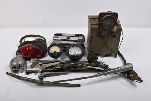 WIPER AND ELECTRIC: Ten assorted wiper blades, one Lucas tail light assembly, one Lucas number plate lamp assembly dismantled, one NOS Bakelite panel meter amp gauge. One NOS Marion Instruments Milliamperes gauge. One vintage battery charger. One trailer 