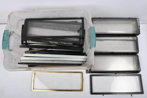 NUMBER PLATE FRAMES: One plastic crate of approximately 50 number plate frames.